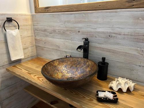 a bathroom with a sink on a wooden counter at Treetops Hotel in Caye Caulker