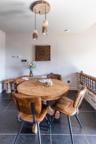 a dining room with a wooden table and chairs at Relax B&B Lavendine Pure in Genk