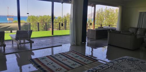 a living room with a couch and a chair and a large window at The Wind Farm in Dahab