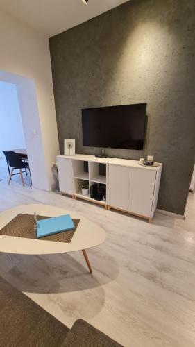 a living room with a television and a table at Apartment near Congress Centre I. in Prague