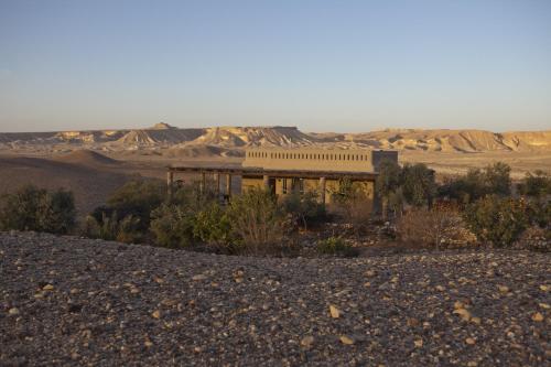 a building in the middle of the desert at Arava Land in Zuqim