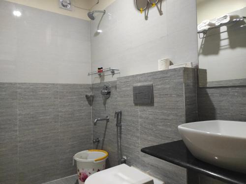 a bathroom with a sink and a shower at Hotel Paradise - Biswanath Chariali in Bishnāth