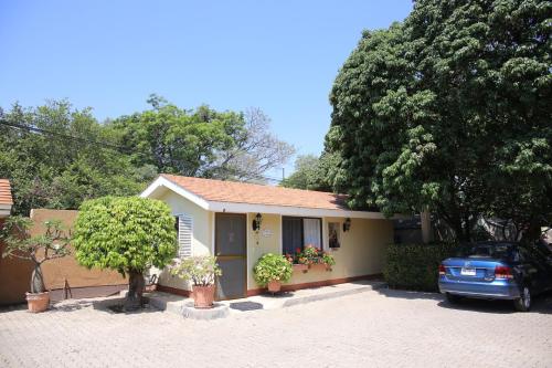 a small house with a car parked in front of it at La Casita de Fraida in Guadalajara