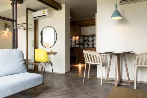 a living room with a table and chairs at karaarom hotel in Bangkok