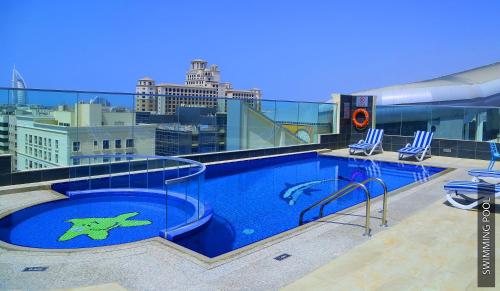 a swimming pool on the roof of a building at Tulip Al Barsha Hotel Apartment in Dubai