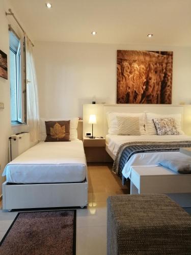 a bedroom with two beds and a painting on the wall at Stella Mare in Tučepi