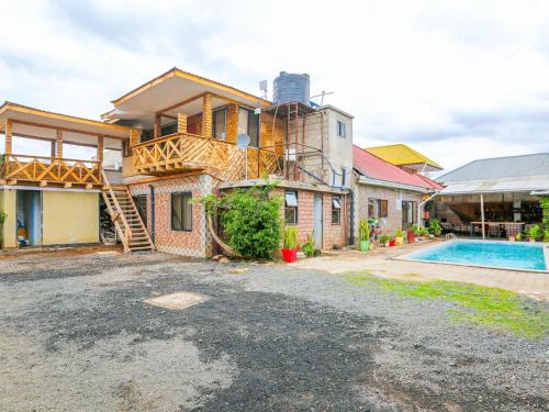 an image of a house with a swimming pool at Arusha Safari Hostel in Arusha