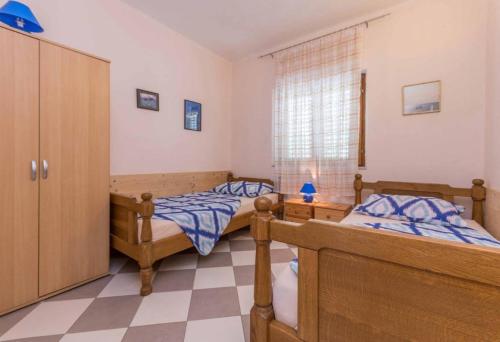 a bedroom with two beds and a window at Neptun apartments in Pirovac