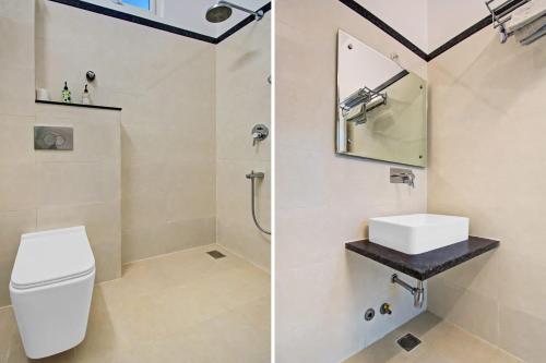 a bathroom with a white toilet and a sink at Grande Azure in Jaipur