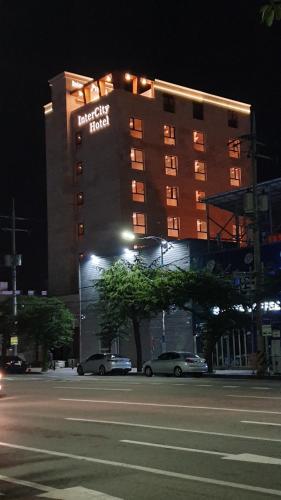 a hotel with a sign on the side of a building at Jinhae Intercity Hotel in Changwon
