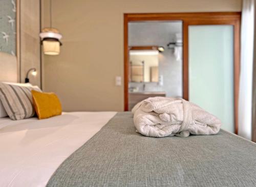 a white towel sitting on top of a bed at Soho Boutique Columela in Cádiz