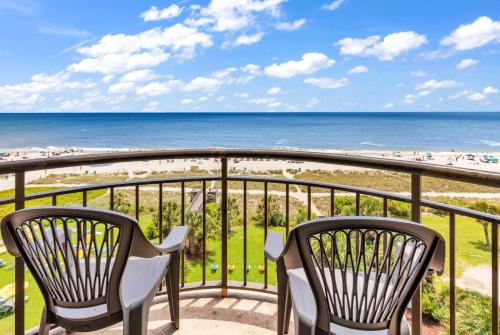 a balcony with two chairs and the beach at Spectacular Oceanfront Condo in Myrtle Beach