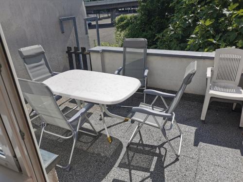 a table and chairs sitting on a patio at Ferdimesse Apartments in Cologne