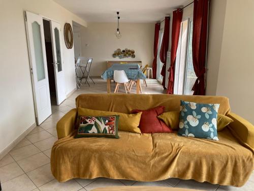 a living room with a couch with pillows on it at Ty Cèdre in Crozon