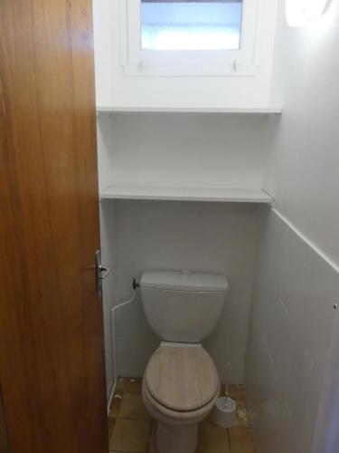 a bathroom with a white toilet with a window at Superbe Maison Rénovée en Centre-ville in Saint-Pierre-dʼOléron