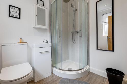 a white bathroom with a shower and a toilet at Silver Stag Properties, Self-Contained Suite in Donisthorpe