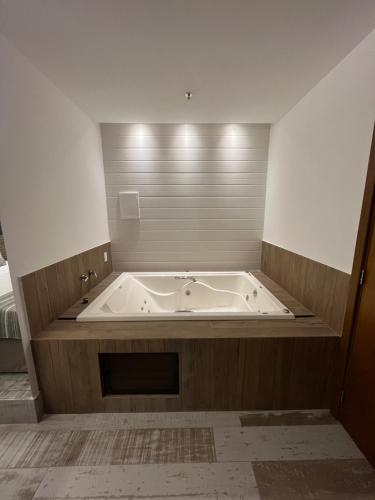 a large bath tub in a room with at Golden Towers Hotel in Macaé