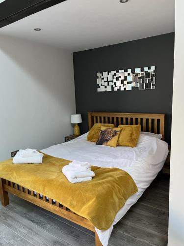 a bedroom with a large bed with towels on it at The Lydden Bell in Dover