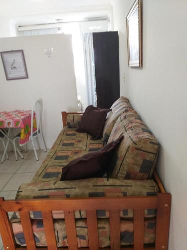 Bett im Wohnzimmer mit Sofa in der Unterkunft Flat em Pitangueiras - Guarujá in Guarujá