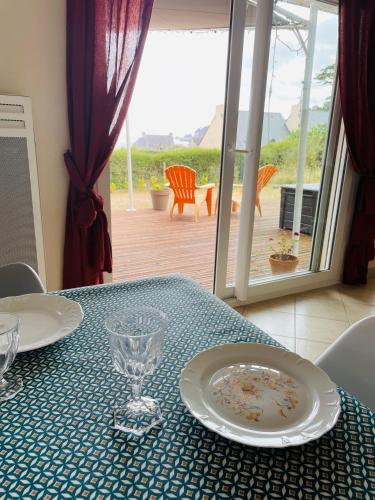 a table with a plate and glasses on top of it at Ty Cèdre in Crozon