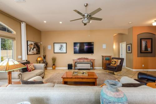 a living room with a couch and a ceiling fan at Casa Dynamite home in Cave Creek