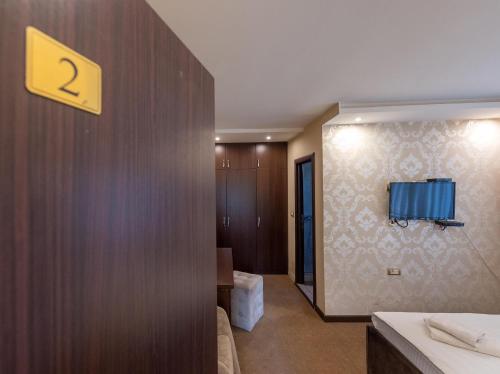 a hotel room with a sign on the wall at Apartments Depandans by Djokovic in Kragujevac
