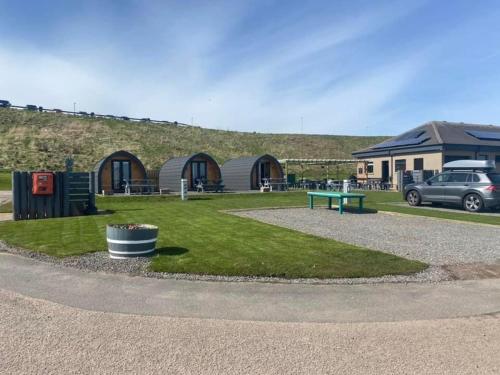 a park with a bench and a building at Marina Bay Pods in Aberdeen