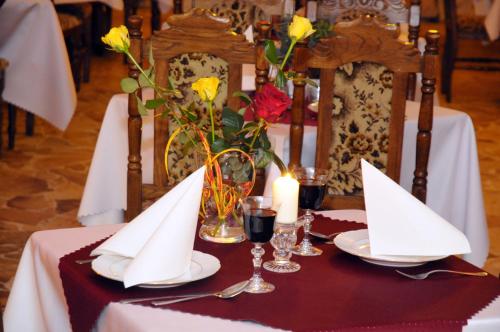 a table with white napkins and glasses on a table at Hotel Galicja SPA Wieliczka in Wieliczka