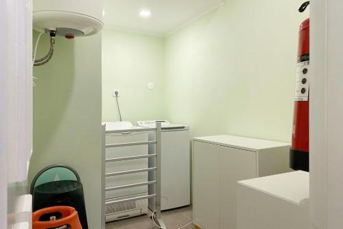 a room with a desk and a red fire hydrant at Casa d'Avó in Miranda do Corvo