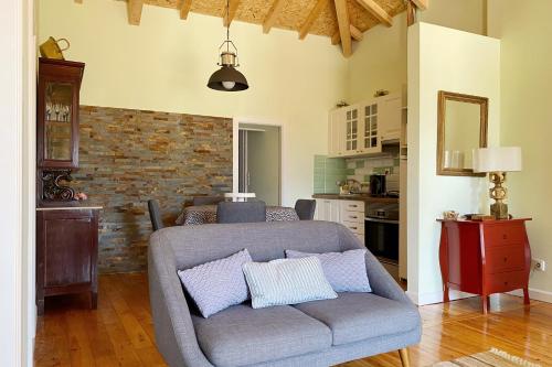 a living room with a couch with pillows on it at Casa d'Avó in Miranda do Corvo