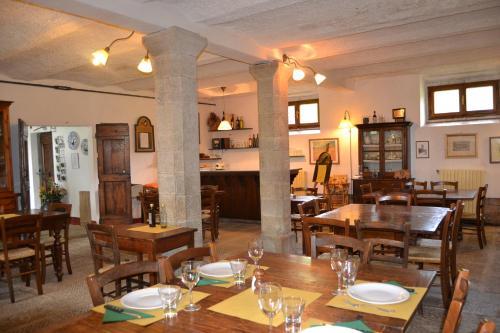 uma sala de jantar com mesas e cadeiras de madeira em Two-room apartment in Tuscan rustic style em La Lama