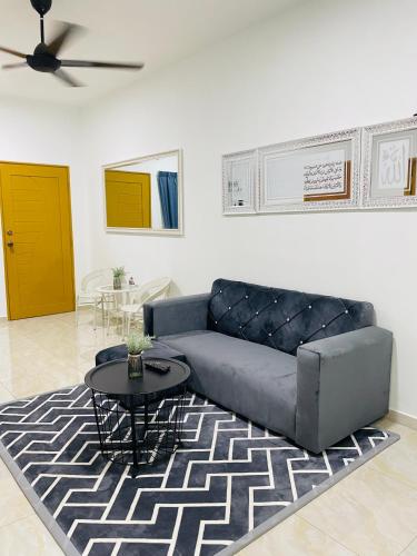 a living room with a couch and a table at AL Homestay Kajang in Kajang