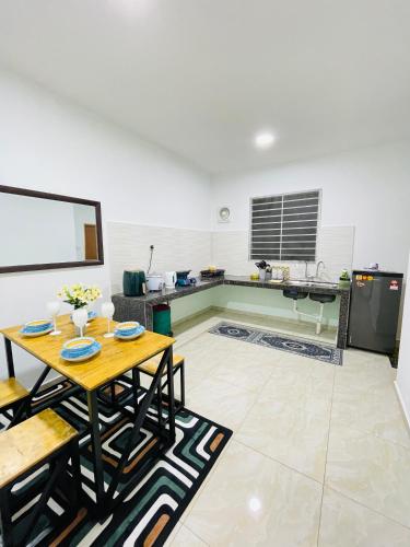 a living room with a table and a kitchen at AL Homestay Kajang in Kajang