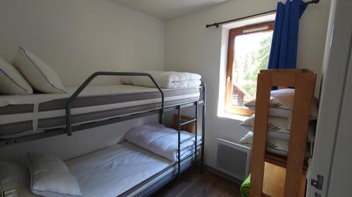 a room with two bunk beds and a window at Residence Les Ecrins in Puy-Saint-Vincent