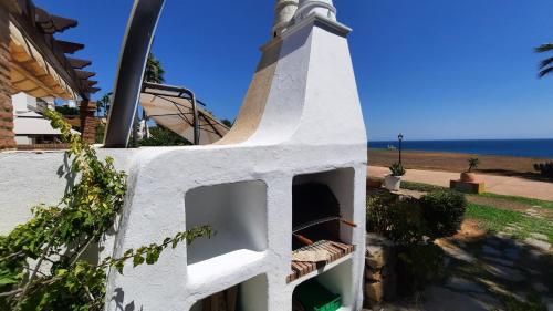a church steeple with the ocean in the background at Loma del Rey 56 - casa primera linea de mar in Alcaidesa