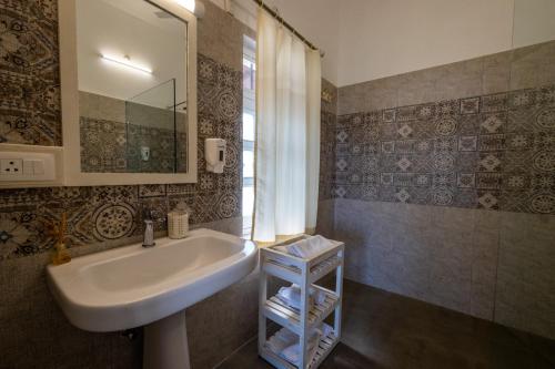 a bathroom with a sink and a mirror at Sajjan Niwas in Udaipur