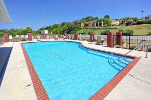 a large swimming pool with blue water at Fantastic Location! River and Mountain Views 2BR/2BA Sleeps 6 in Pigeon Forge