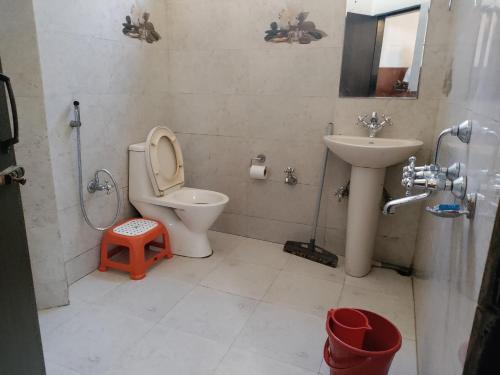 a bathroom with a toilet and a sink at The Shillong Hills Guest House in Shillong