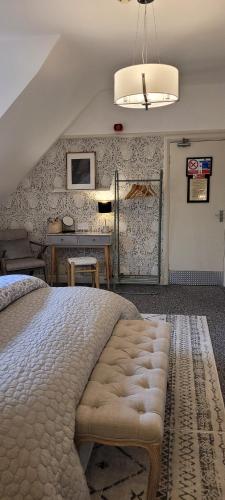 a bedroom with a large bed and a desk at Rigsbys Guesthouse Doncaster in Doncaster