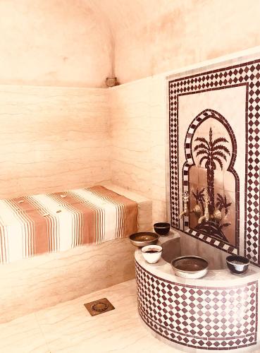 a room with two beds and a table with bowls at Riad Le Coq Berbère in Marrakech