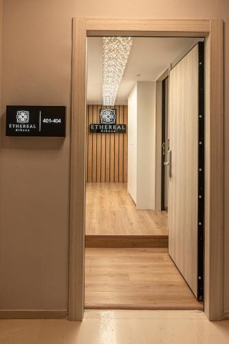 a door leading into a room with a hallway at Ethereal Athεns in Athens