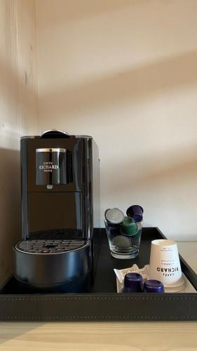 a microwave sitting on top of a counter at LE CLOS DES SOURCES Hôtel & Spa in Thannenkirch