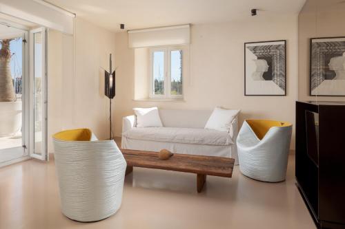 a living room with a couch and a table and chairs at Ribarska Koliba Resort in Pula