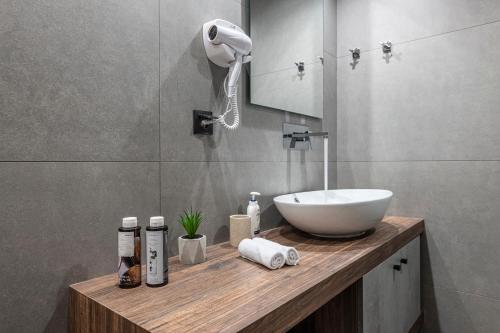 a bathroom with a white sink and a mirror at Ethereal Athεns in Athens