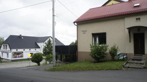 a house with two white houses and a street at Fantazja Góra Św Anny in Góra Świętej Anny