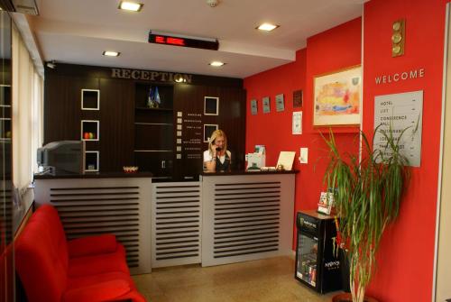 a woman standing at a counter in a restaurant at Hotel Real in Plovdiv