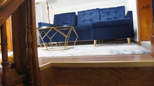 a blue couch sitting inside of a room at Fantazja Góra Św Anny in Góra Świętej Anny