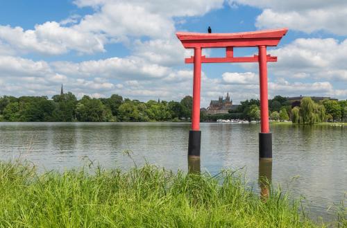 a giant red object in the middle of a lake at ☆ L'Exotique ☆ 2 chambres ☆ NETFLIX ☆ in Metz