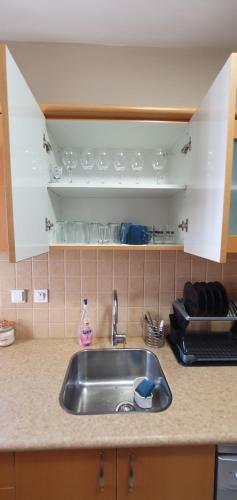a kitchen counter with a sink in a kitchen at Riviera palace Eilat in Eilat