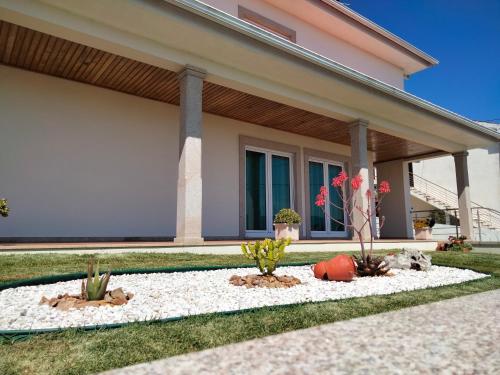 a home with cacti in the front yard at Casa da Calçada in Mujães
